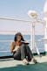 a woman sitting on a boat reading a book