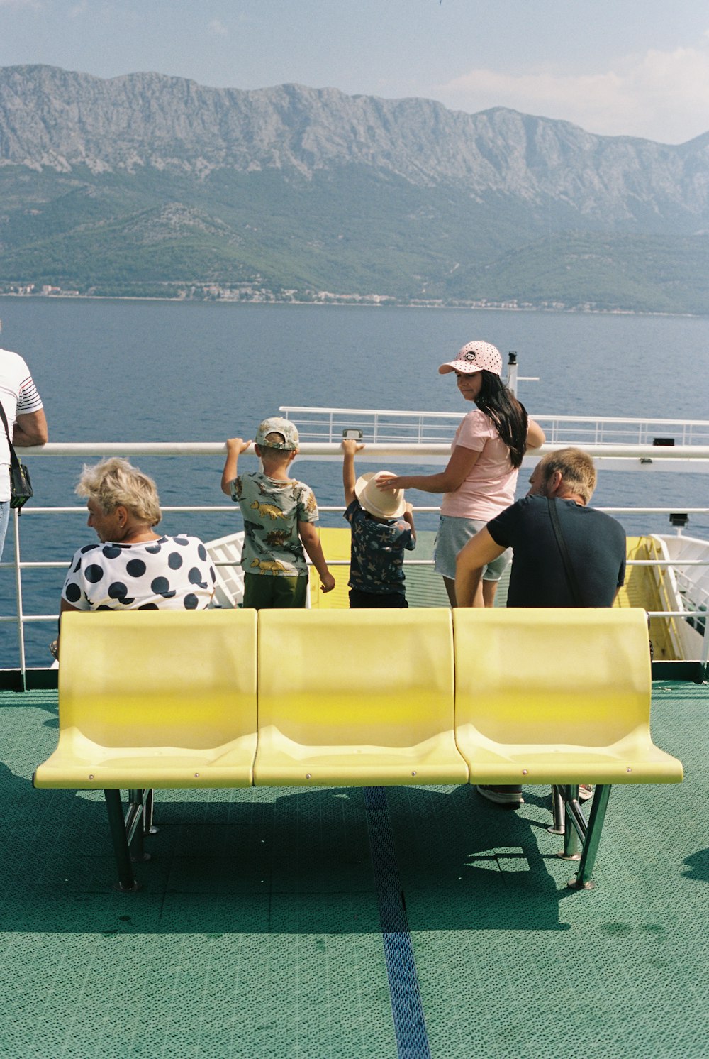 a group of people sitting on a yellow bench