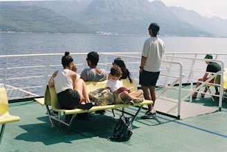 a group of people sitting on top of a yellow bench