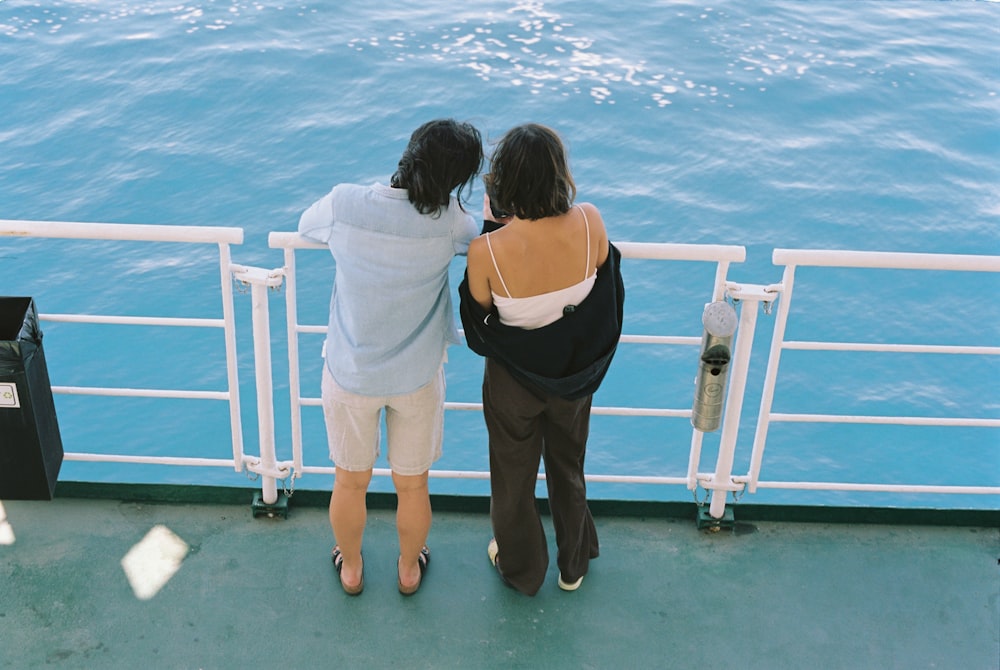 a couple of women standing on top of a boat