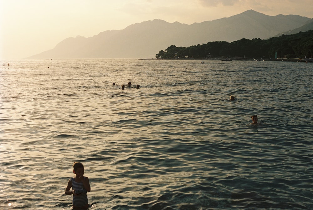 a group of people swimming in the ocean