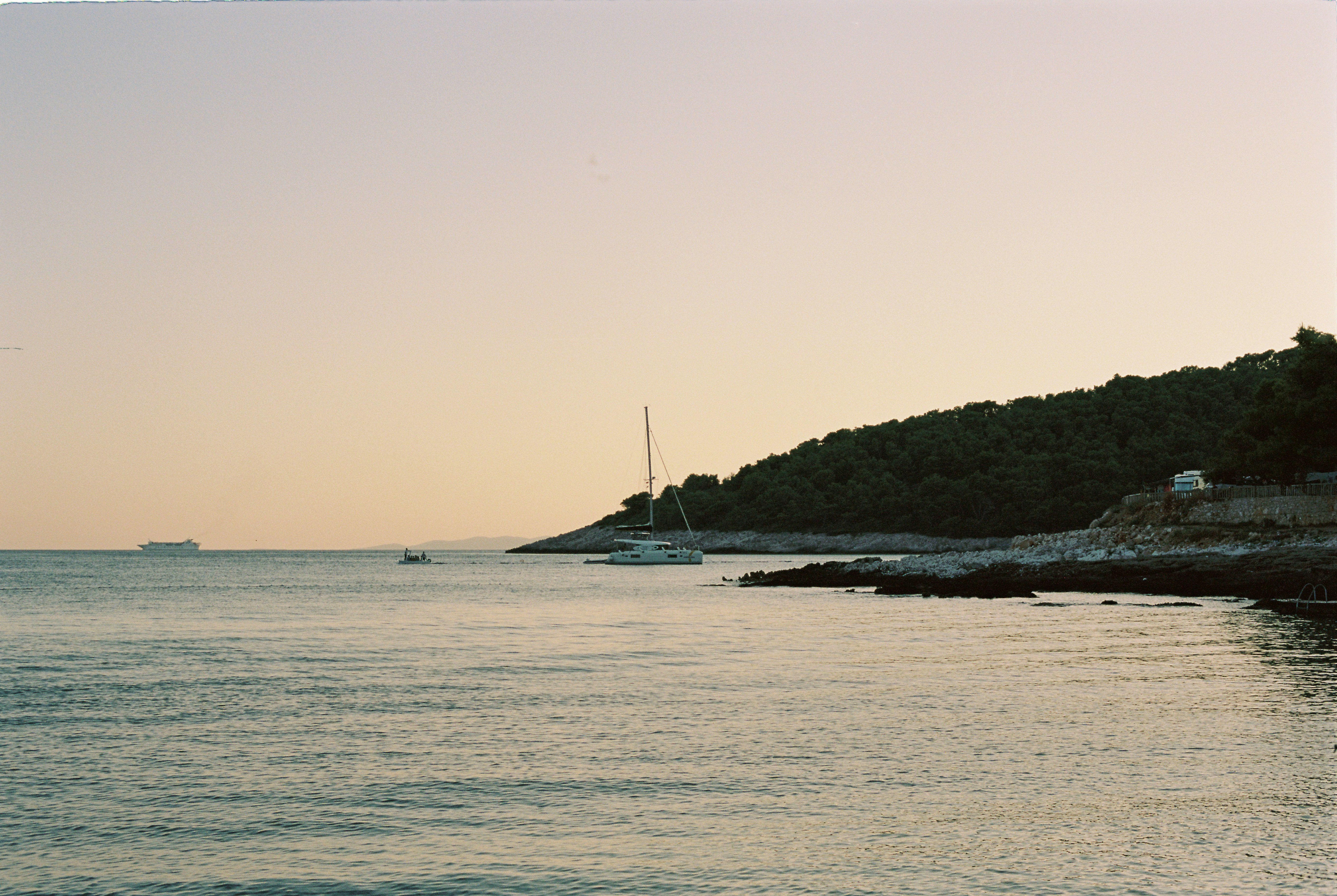 a boat is out on the water at sunset, 