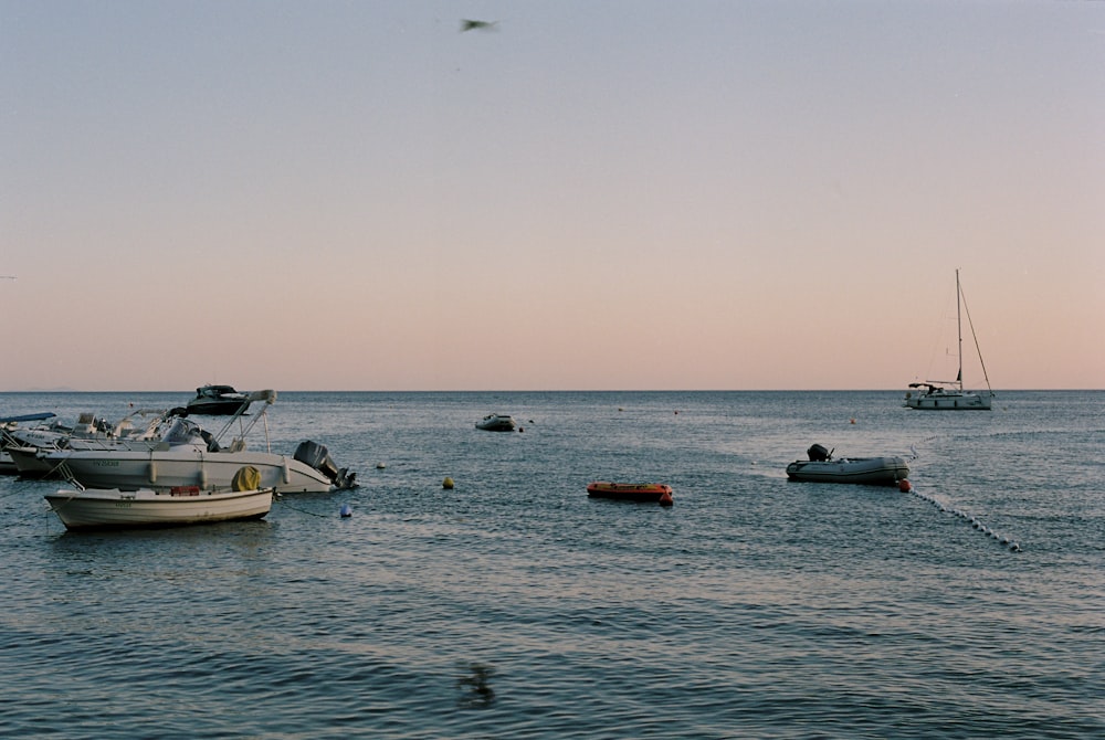 a group of boats floating on top of a body of water