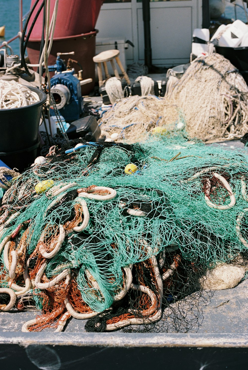 a pile of fishing nets sitting on top of a boat