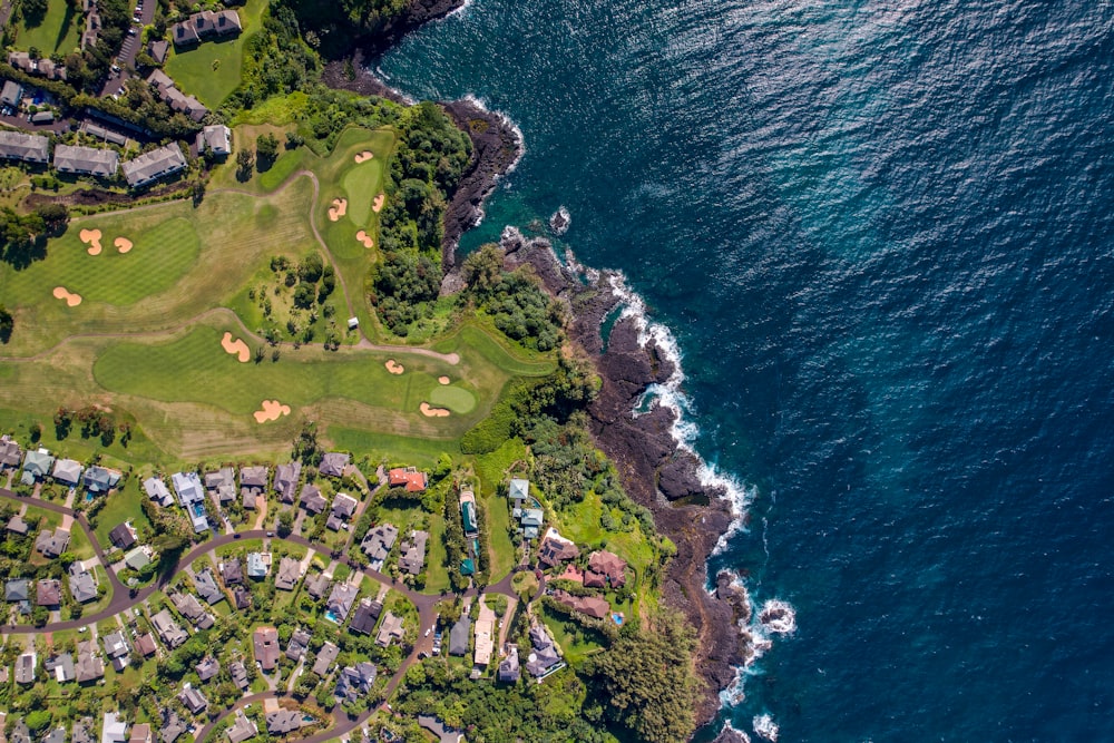 an aerial view of a golf course next to the ocean