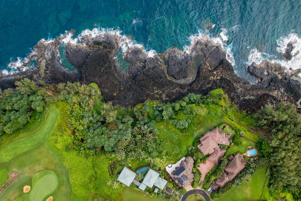 a bird's eye view of a golf course near the ocean