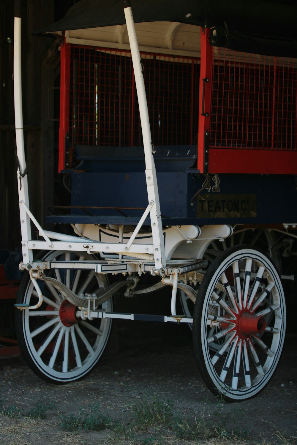 a horse drawn carriage sitting in a barn