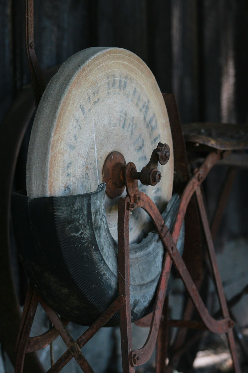 an old spinning wheel on a metal stand