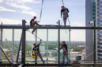 A team installing electrical systems inside a commercial tower under construction.