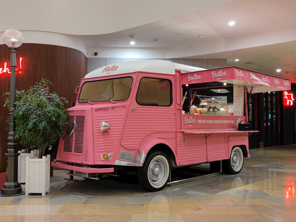 a pink food truck parked in a building