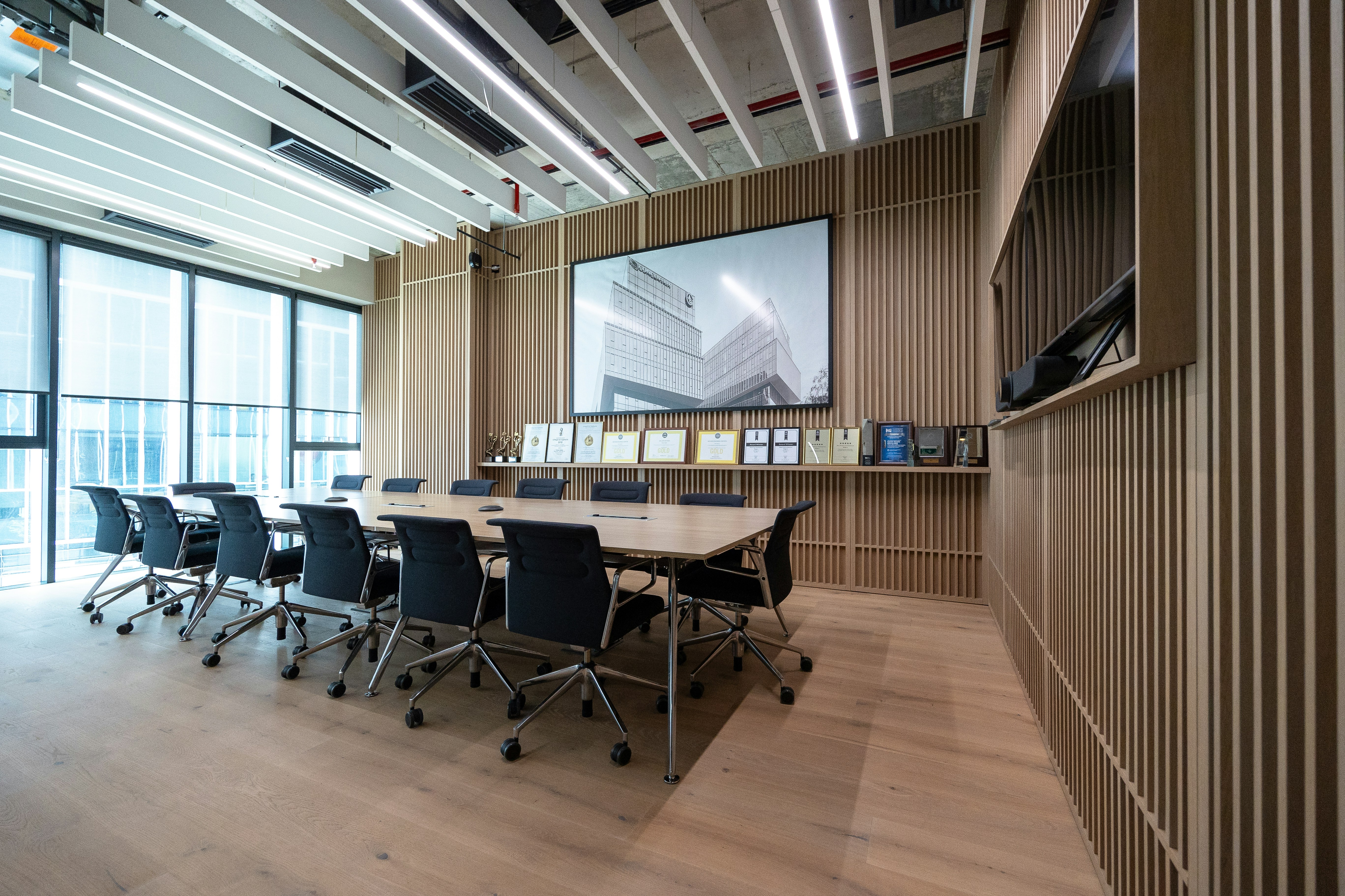 modern enterprise boardroom with video conference screens displaying data analytics