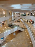a group of people walking up and down an escalator