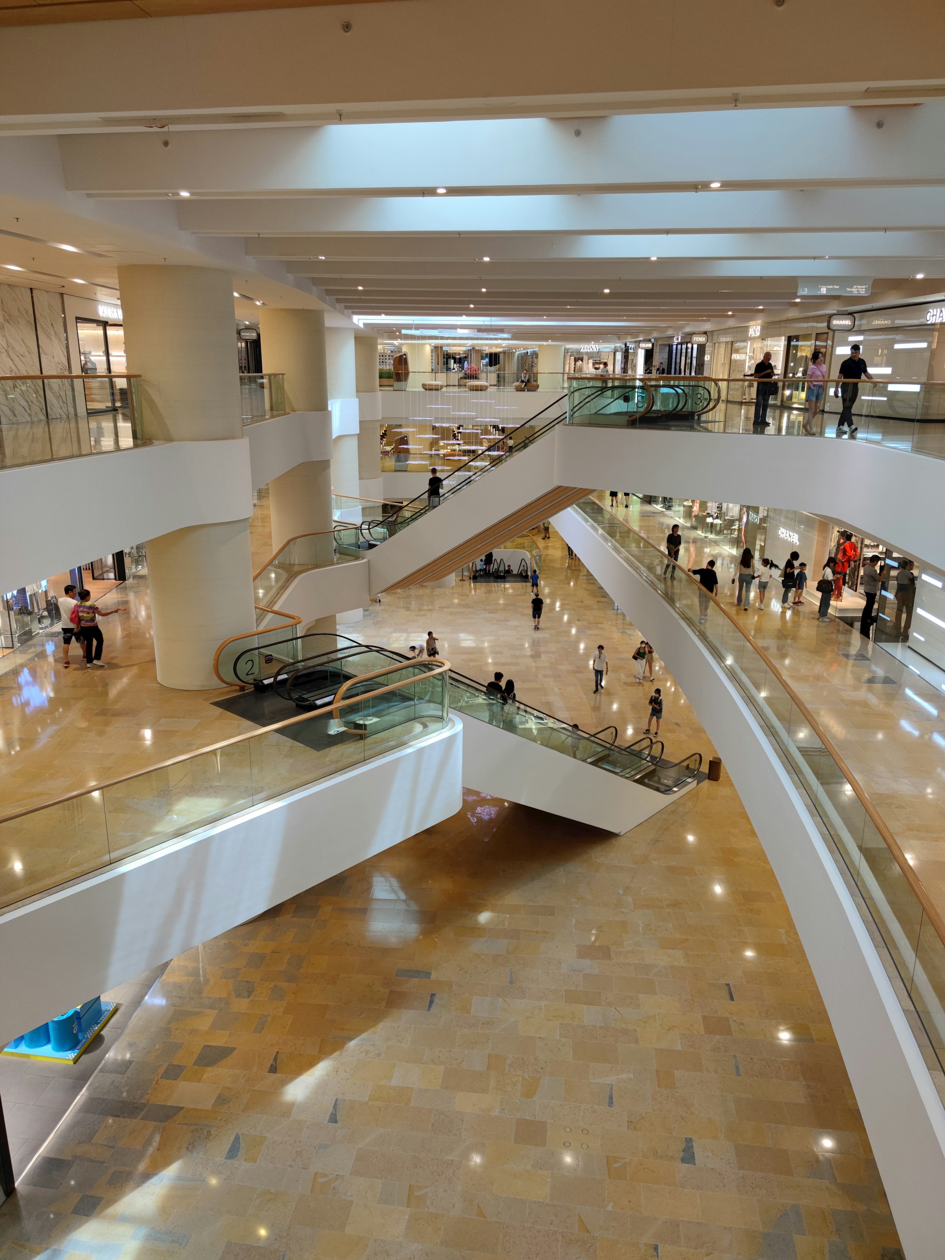 a group of people walking up and down an escalator
