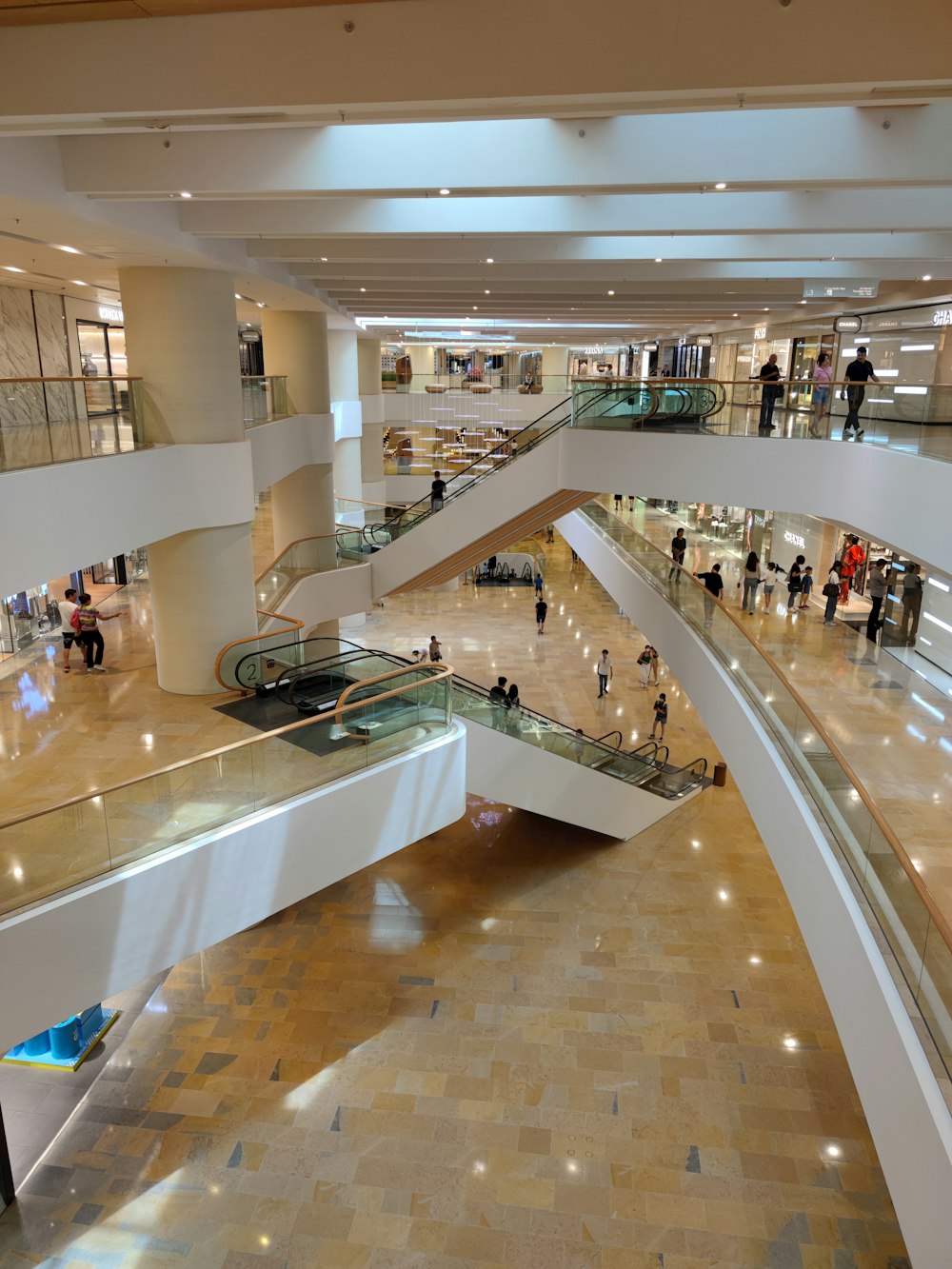 a group of people walking up and down an escalator