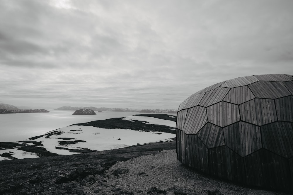 a black and white photo of a dome on top of a hill