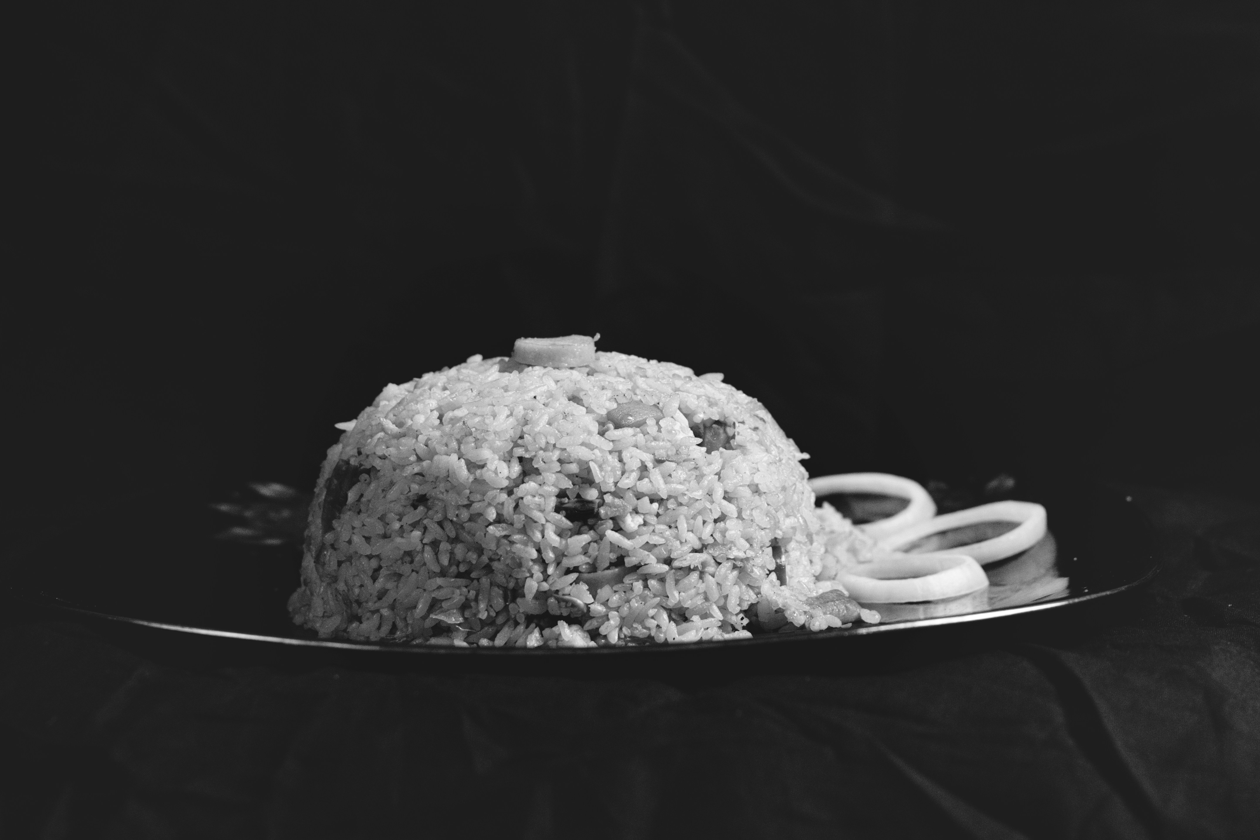 a black and white photo of a cake on a plate