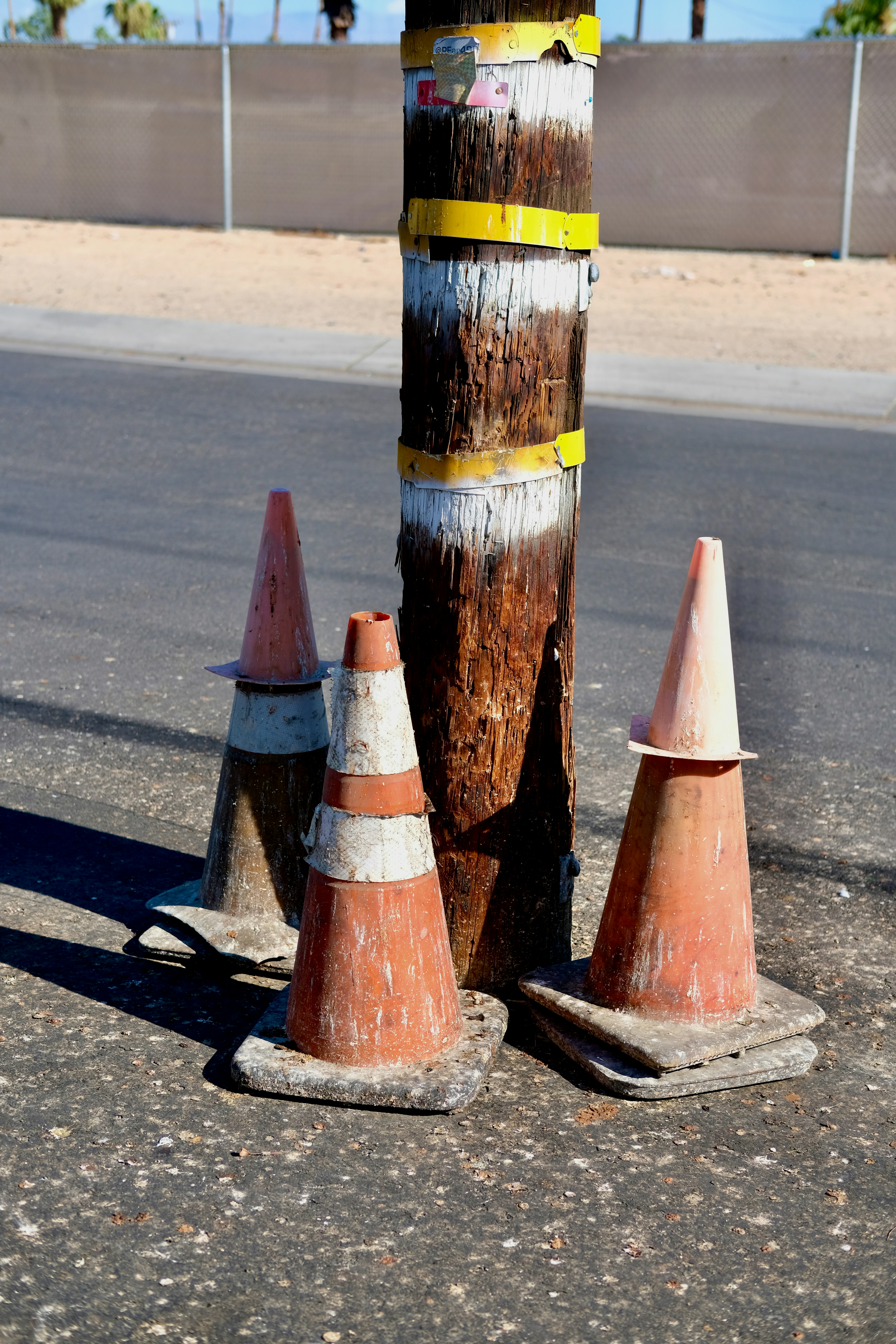 a group of traffic cones sitting on the side of a road