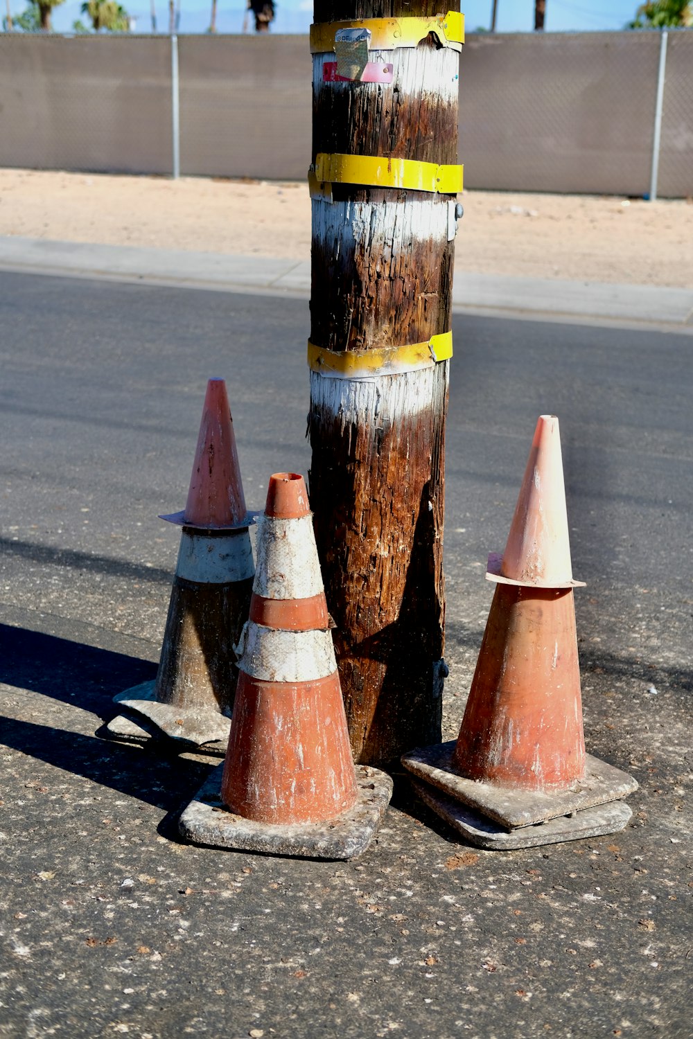 a group of traffic cones sitting on the side of a road