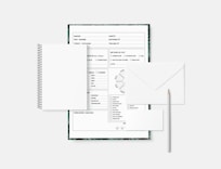 a notebook with a pen and paper on top of it