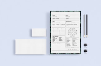 Close-up of a checklist and workflow templates printed on warm white paper with a muted peach background.