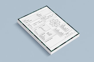 A stack of forms placed against a light blue background. Each form contains various sections including checkboxes, a circular diagram, tables, and lines for handwritten information. The forms also have a decorative border featuring green patterns.