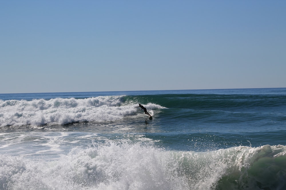 a person riding a surfboard on a wave in the ocean