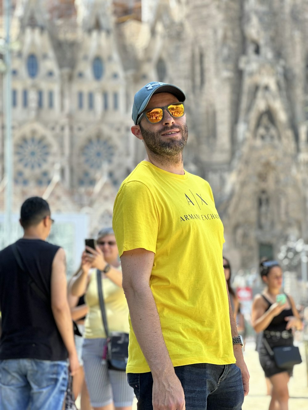 a man in a yellow shirt is standing in front of a group of people