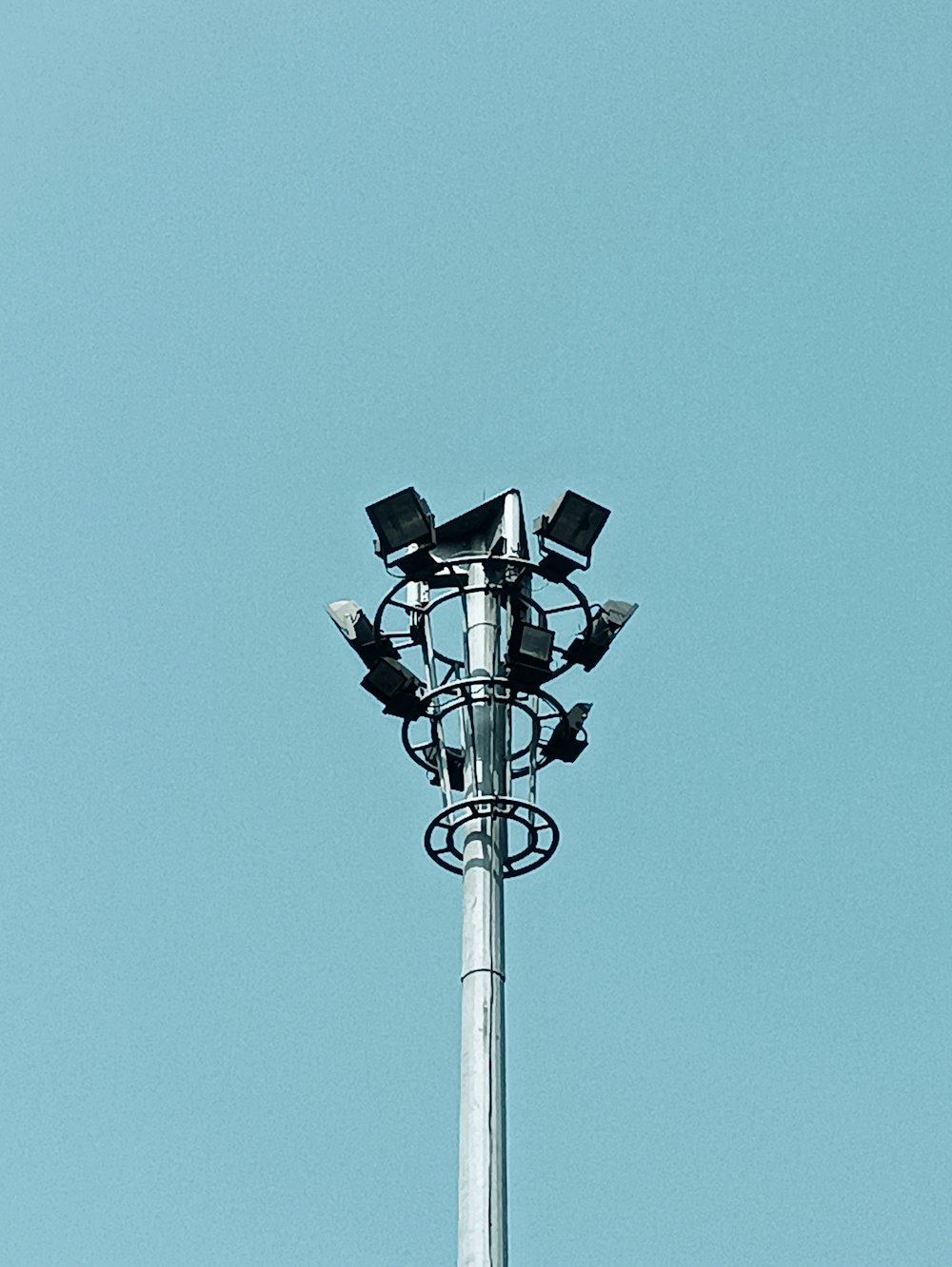 a tall metal pole with a bunch of lights on top of it