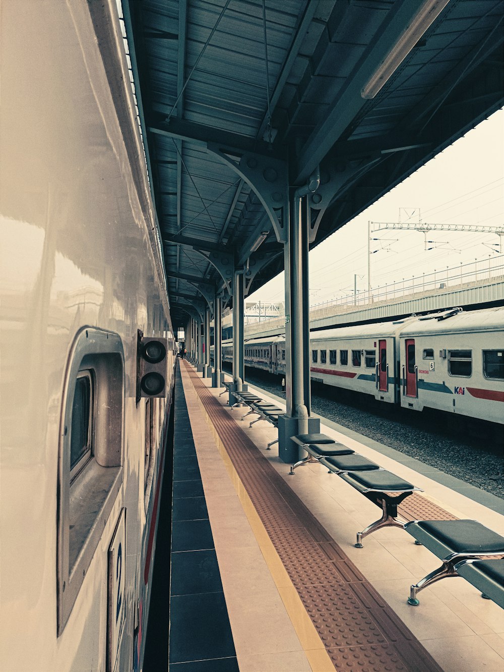 a train pulling into a train station next to a platform