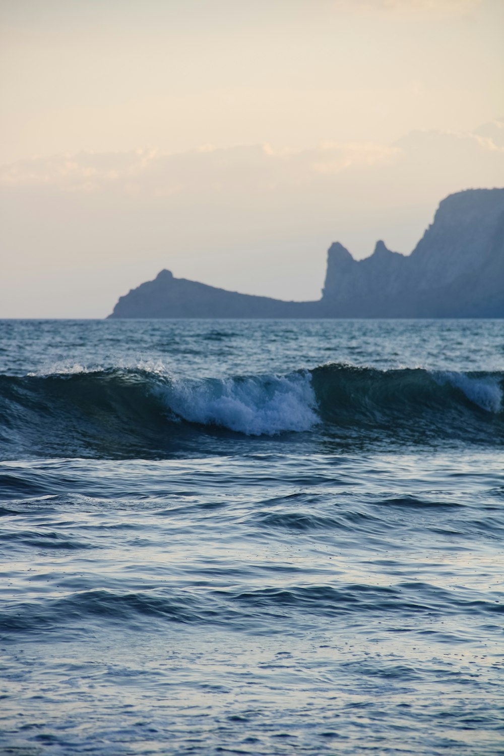 a large body of water with a small island in the background