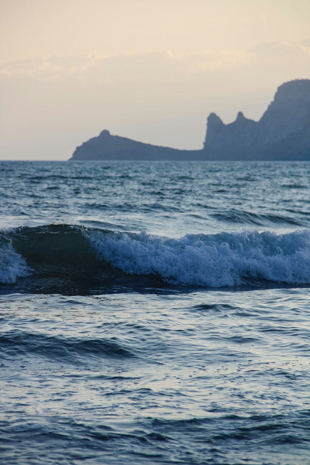 a person riding a surfboard on a wave in the ocean