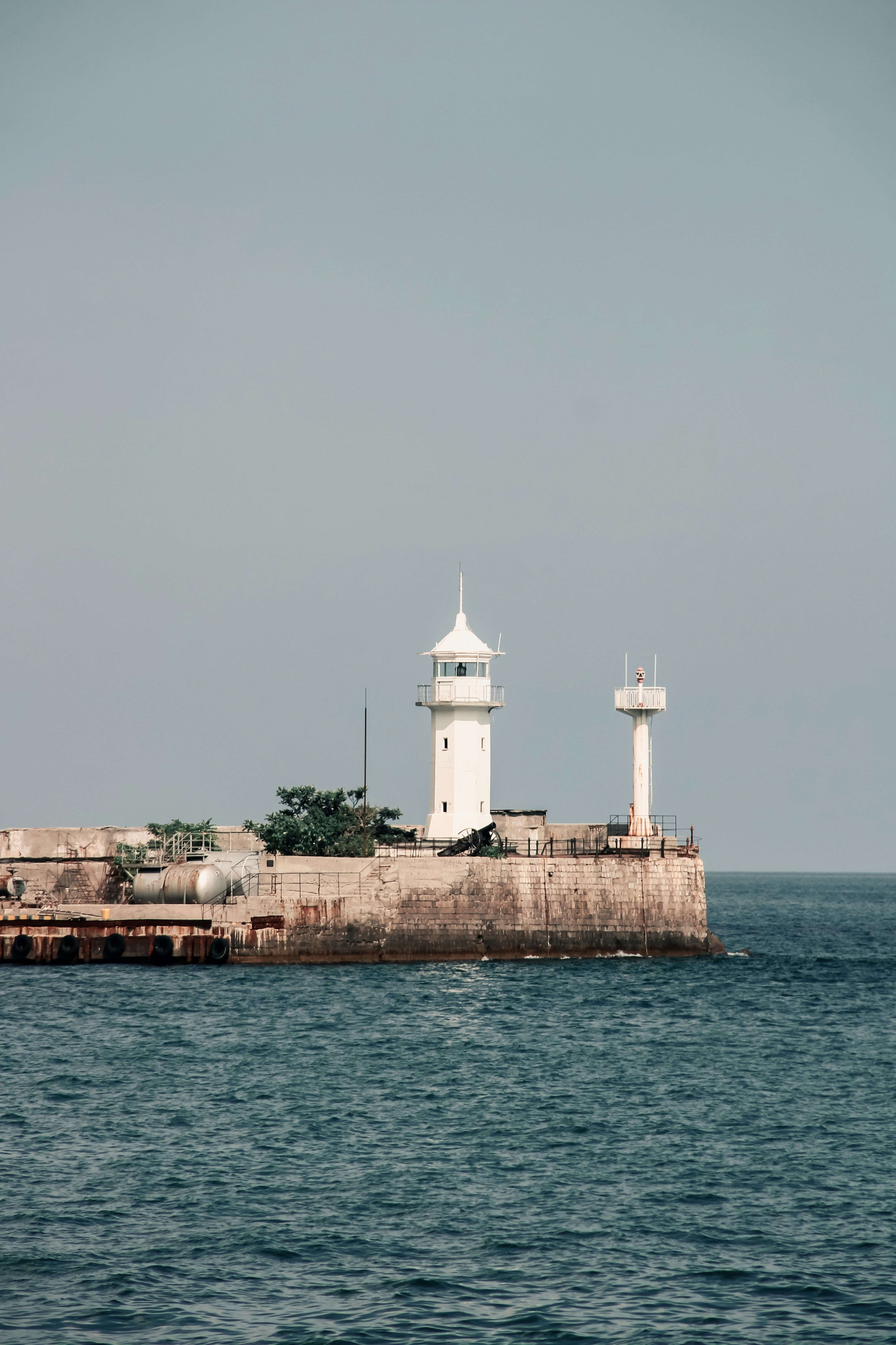 a large body of water with a lighthouse on top of it