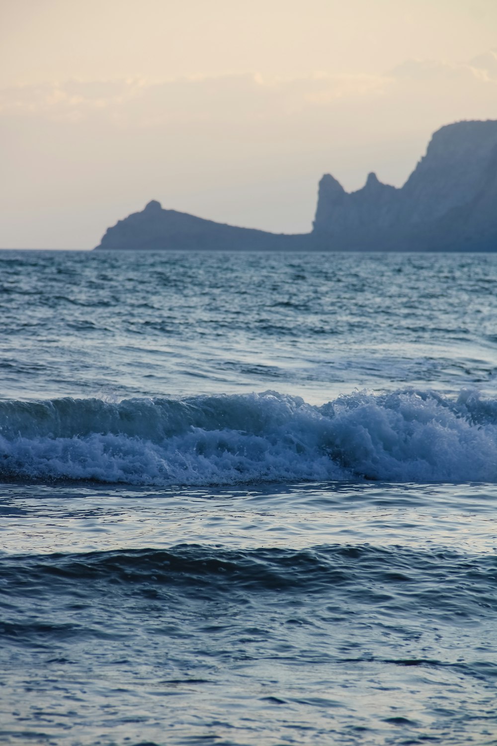 a person riding a surfboard on a wave in the ocean