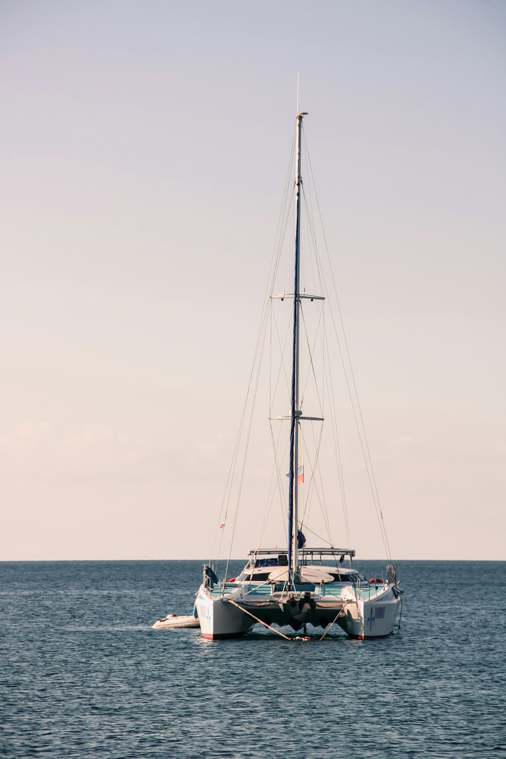 a sailboat floating in the middle of the ocean