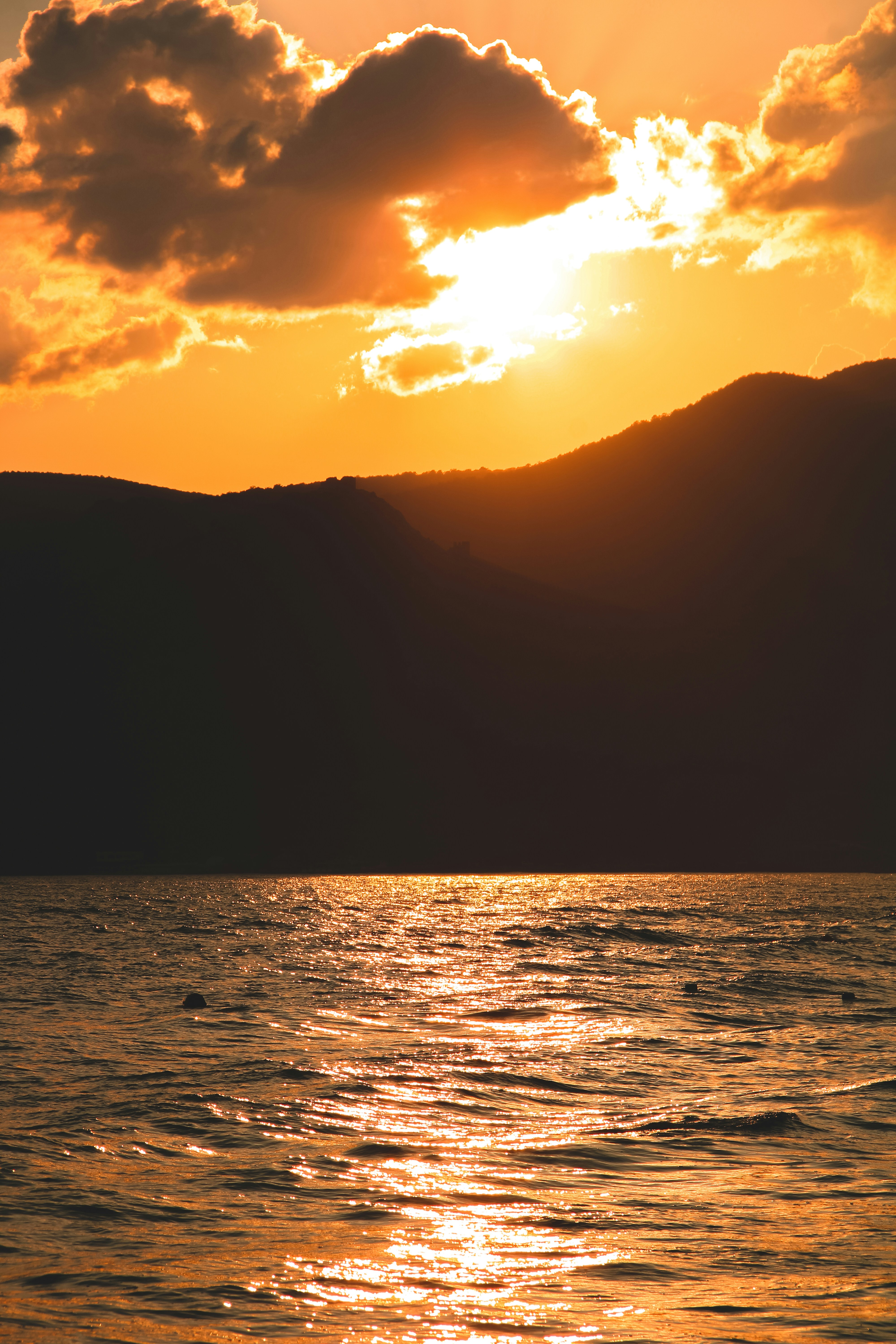 a large body of water with a mountain in the background