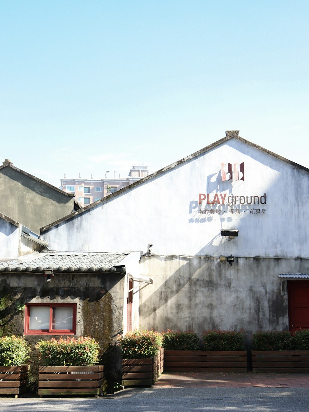 a large white building with a red door