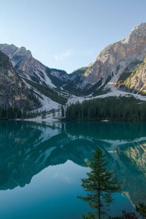 A serene mountain landscape reflecting in a crystal-clear lake.