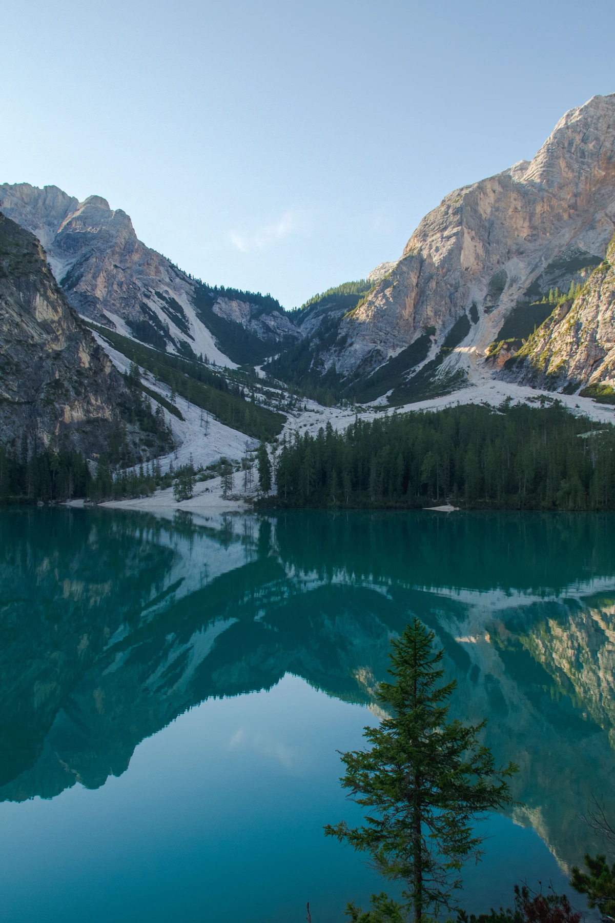 Dramatic mountains beside a clear alpine lake