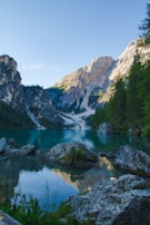 A serene mountain lake reflecting the sky, evoking calm and freshness.