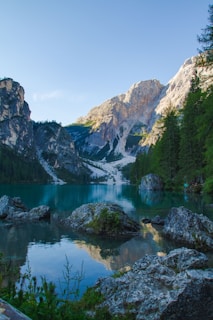 A serene mountain lake reflecting the sky, evoking calm and freshness.