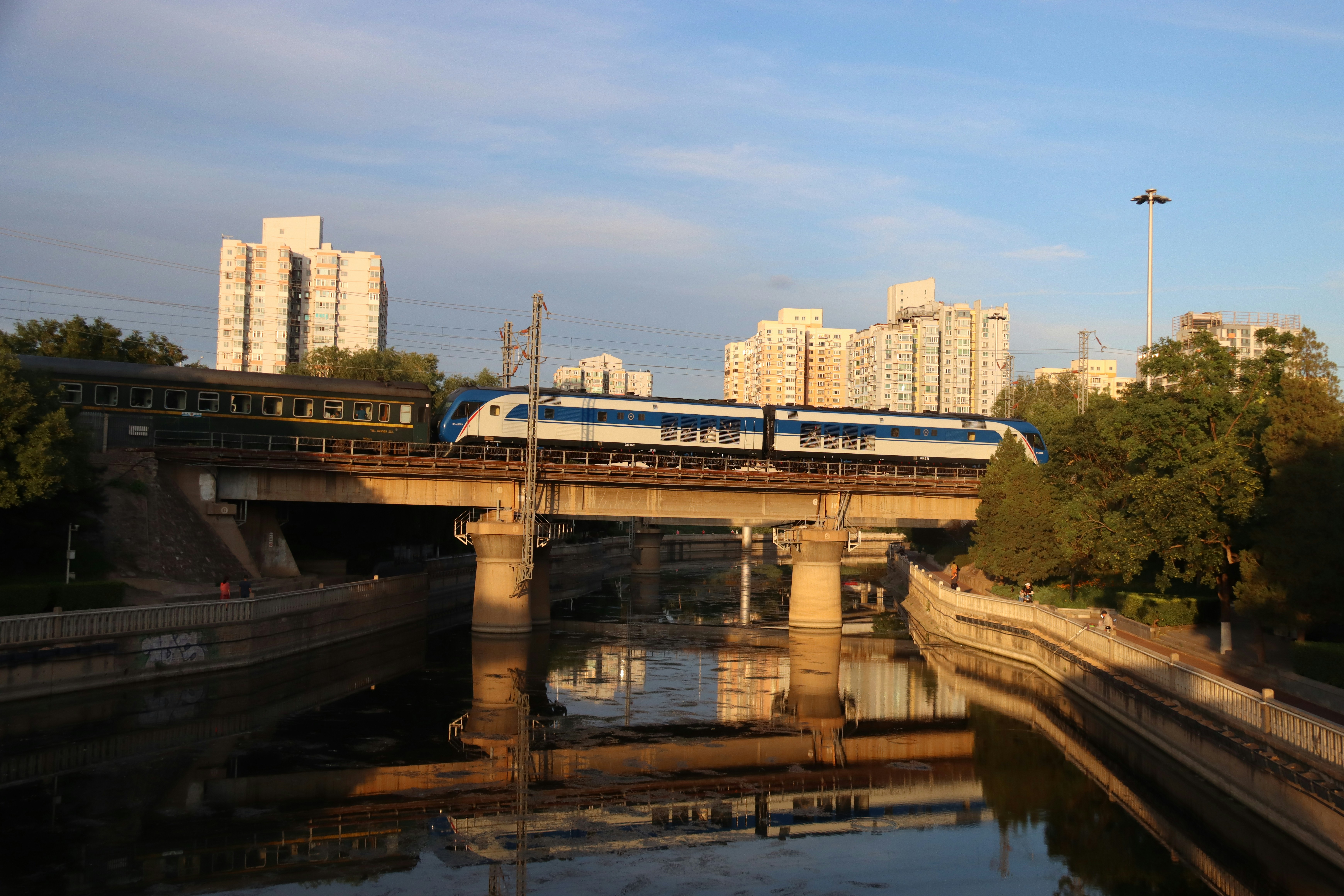 A train traveling over a bridge over a river photo – Free Train Image ...