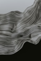 Flowing, wavy lines create a dynamic pattern resembling a wave or fabric in motion. The intricate contours and smooth curves give a sense of fluidity and movement.