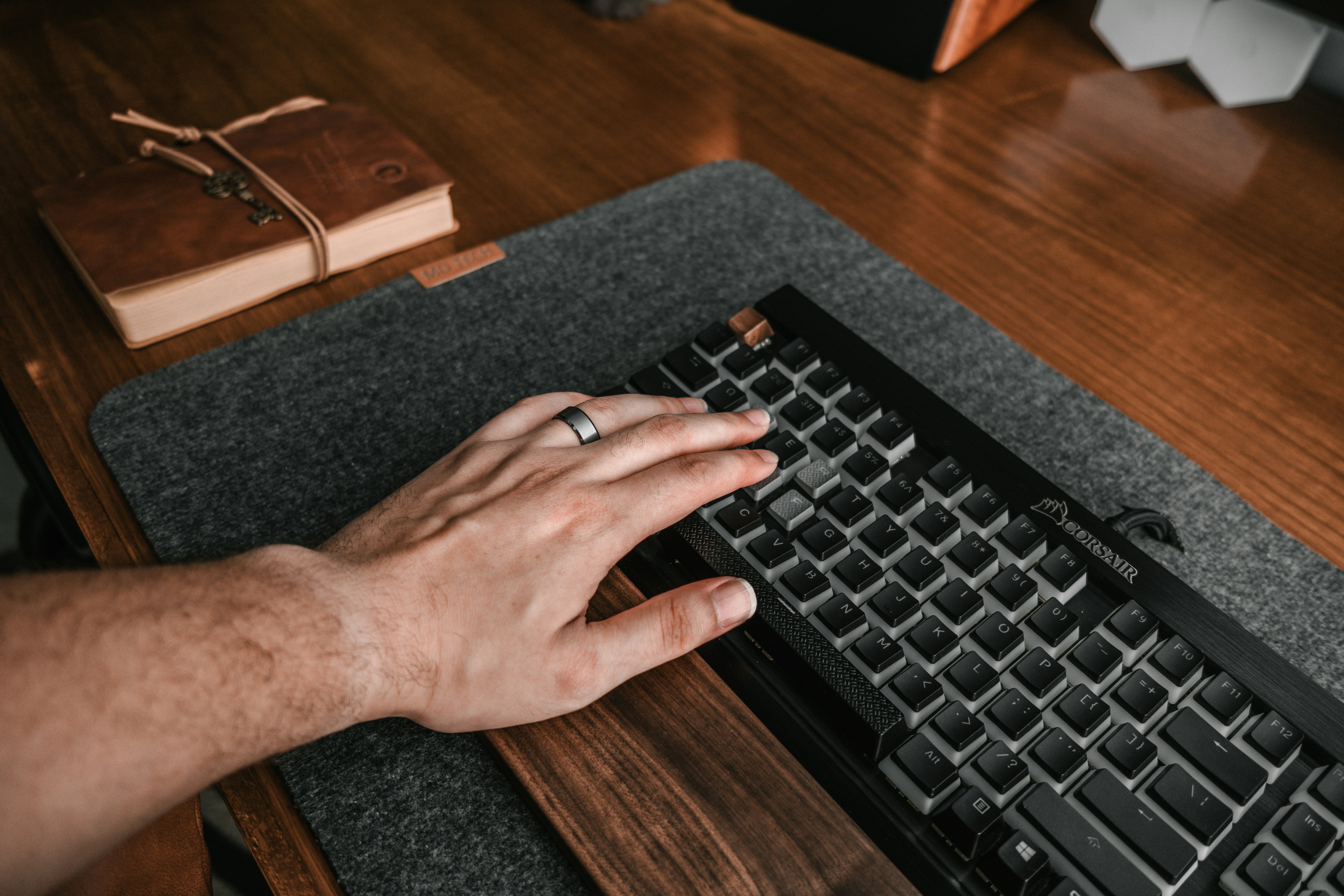a person is typing on a black keyboard