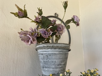 A rustic arrangement of lavender and baby’s breath in a vintage ceramic pot.