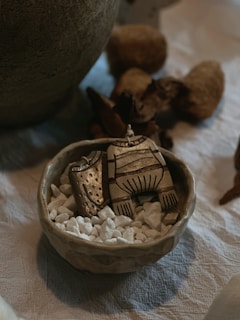 Mixed media piece combining ceramics, metal accents, and wood elements in harmony.