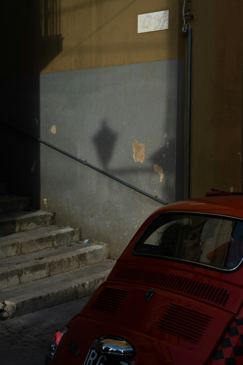 a red car parked in front of a building