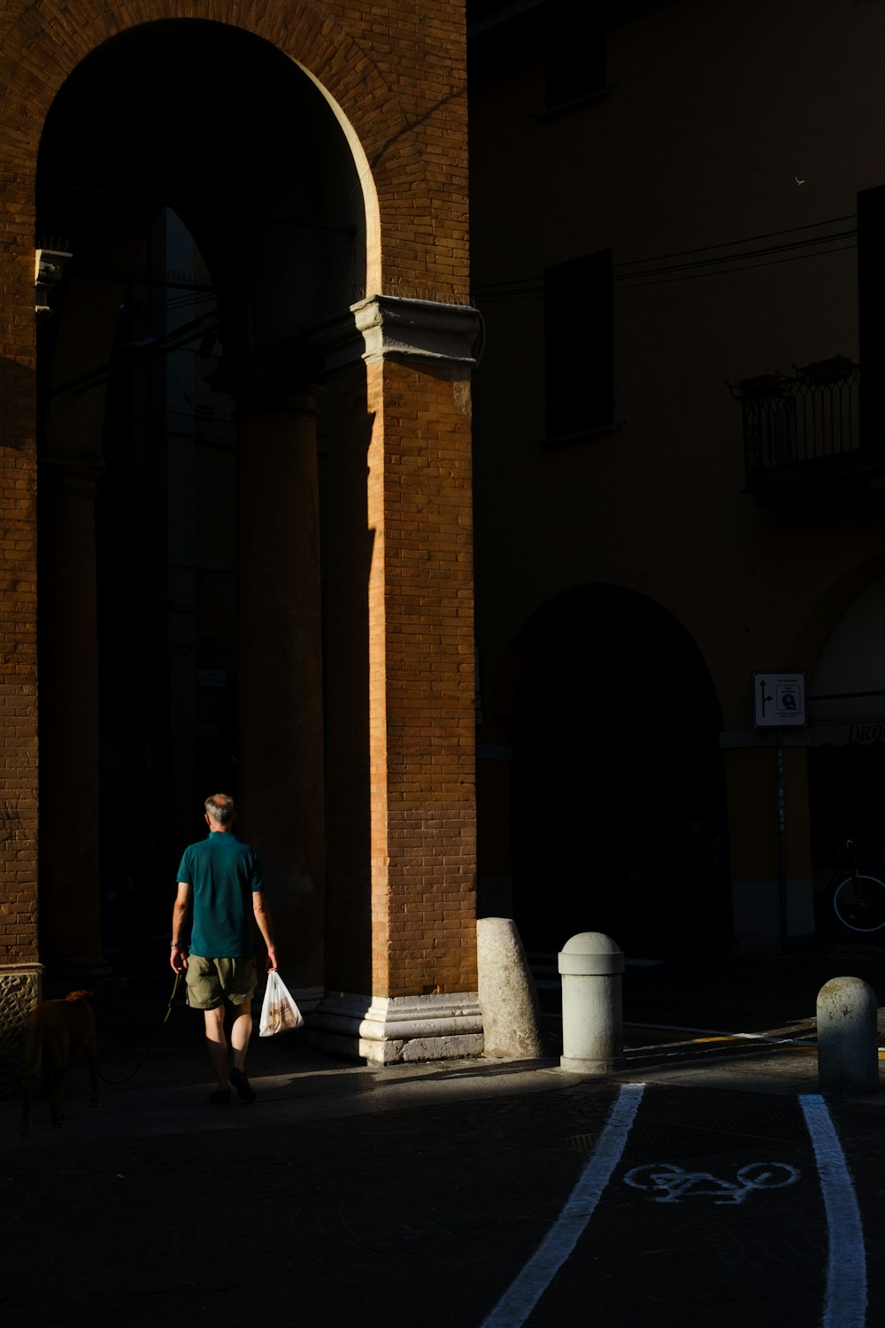 a person walking down a street with a bag