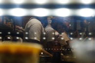 Warm ambient photo of our kitchen team preparing fresh snacks, with urban eco-friendly décor in the background.