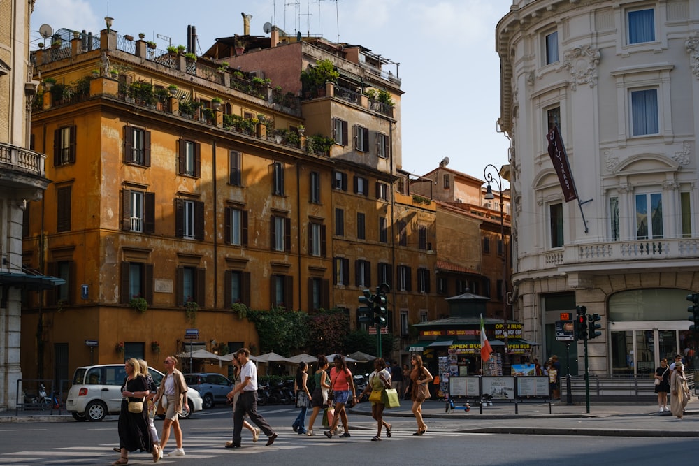 a group of people crossing a street in a city