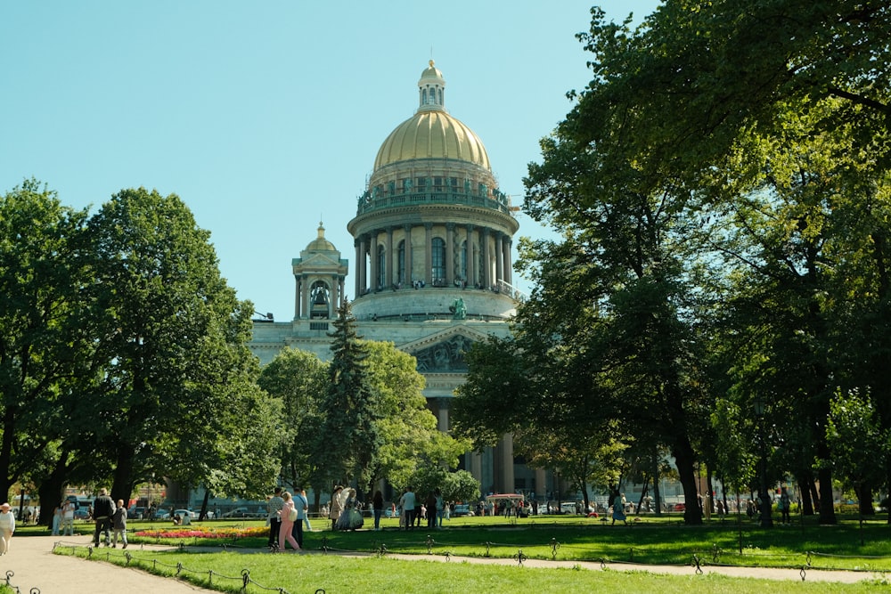 a large building with a dome in the middle of a park